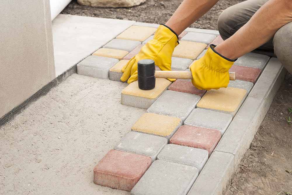 blocks being placed into paving